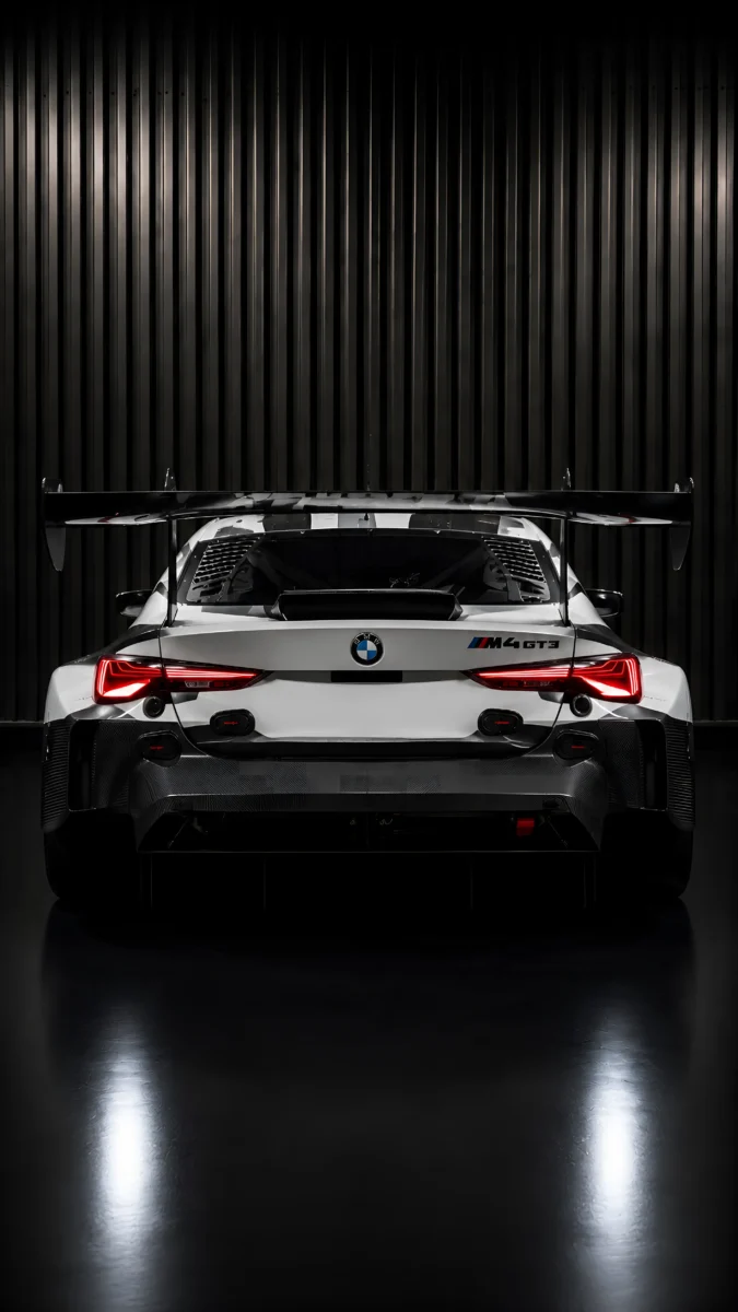Hd image of rear view of BMW M4 GT3 with illuminated taillights, perfect for bmw car wallpaper, bmw m4 gt3 wallpaper phone, and bmw photo.
